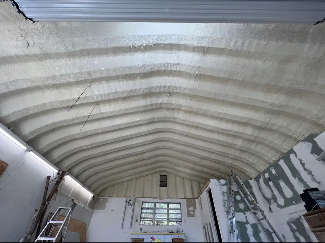 Spray polyurethane foam applied to the underside of a metal roof deck in Four Corners
